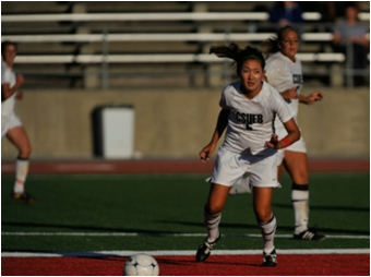 CSUEB women's soccer player Kara Yamamoto scoring a goal.